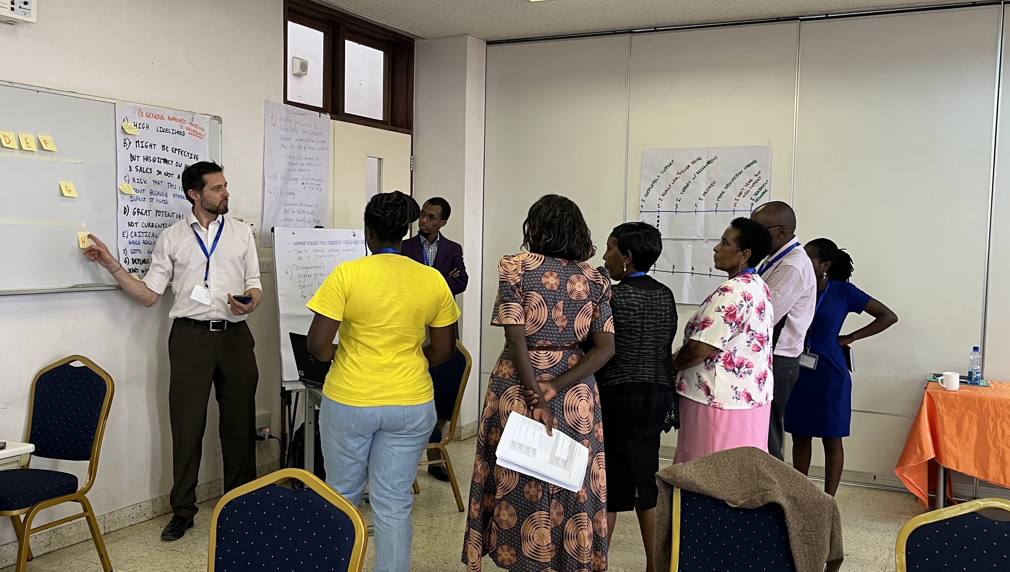 A man speaks to a small group during the Chakula Salama Risk Ranking Workshop