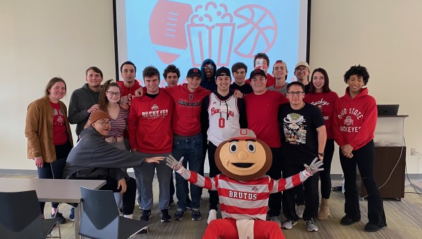 Group of Ohio State students standing with Brutus Buckeye at a meet and greet
