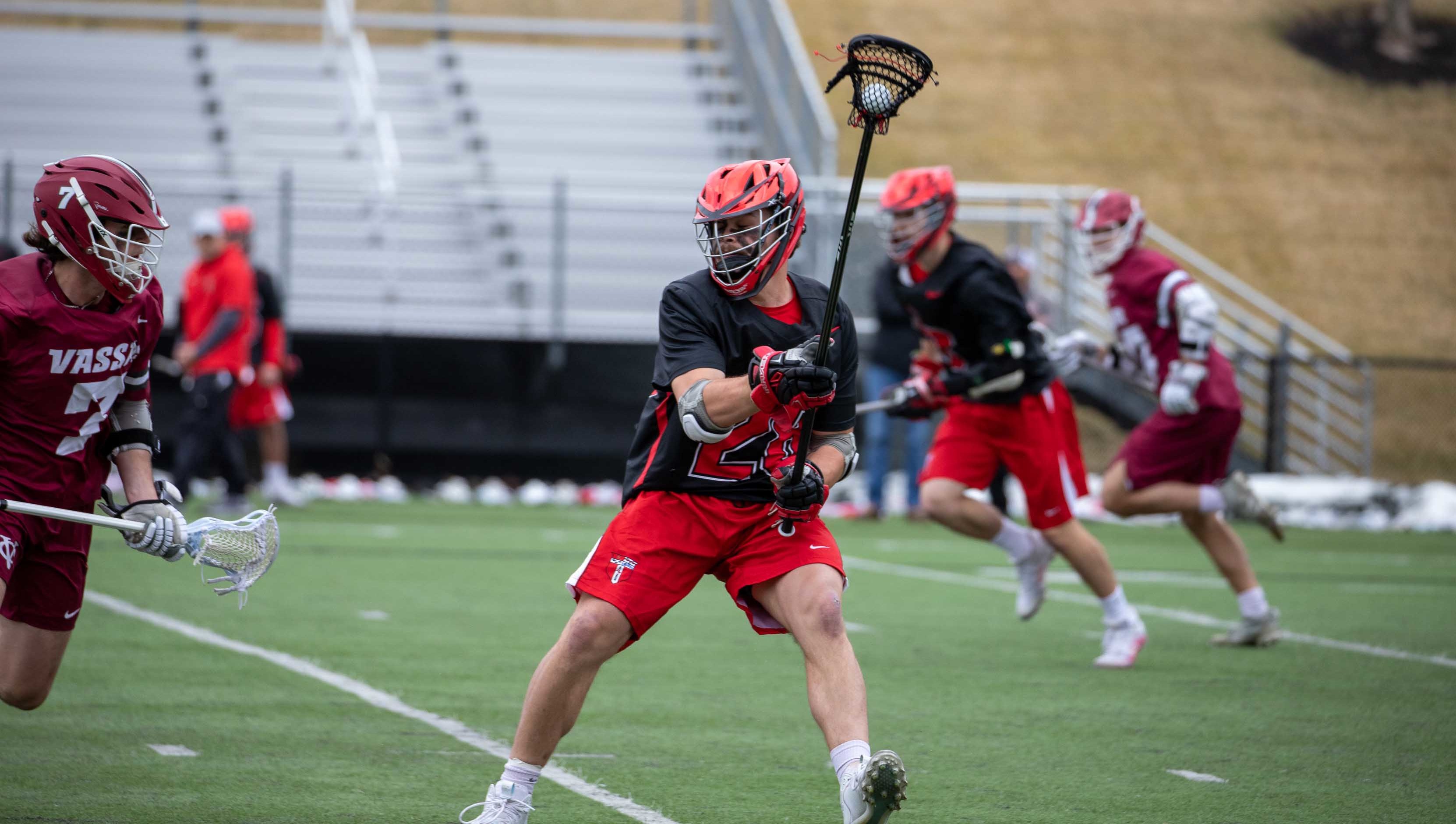 Lacrosse players on the field during a game.