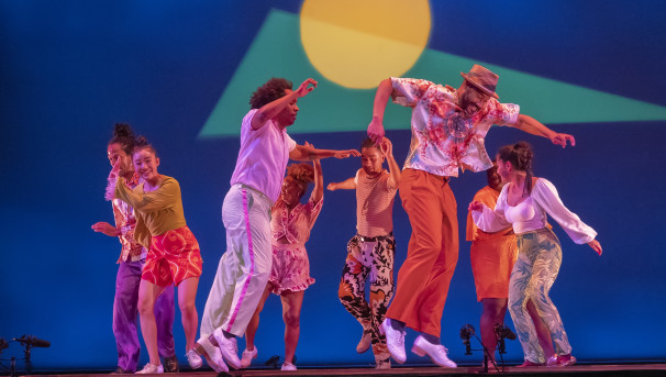 Music from the Sole performers on stage dancing with bright colored backdrop