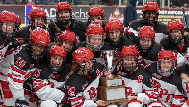 The women's hockey team holding the Mayor's Cup trophy.