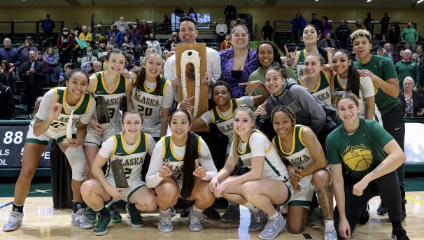 UAA Women's Basketball holding trophy winning the Great Alaska Shootout