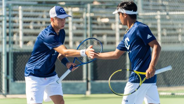 Doubles team giving each other a high-five after a play.