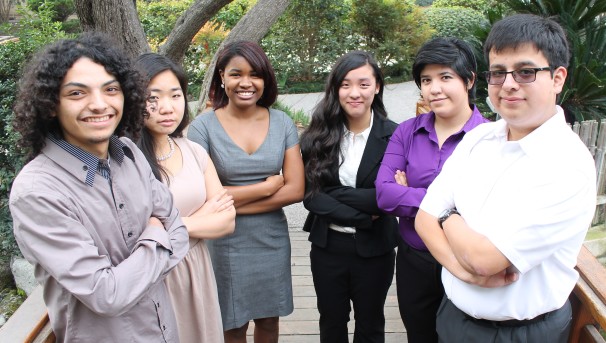 Six students standing on a bridge.