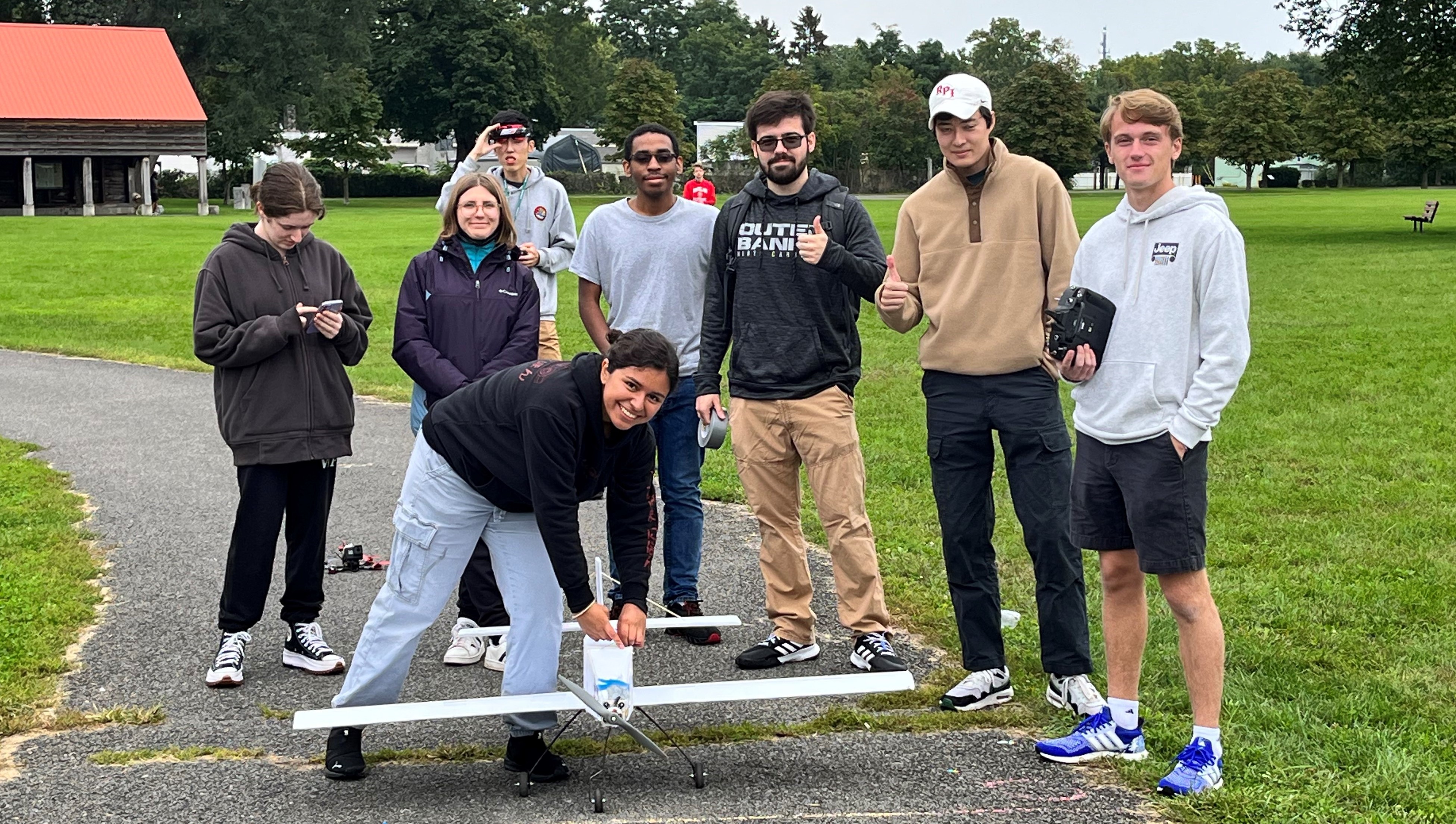 Members of Design Build Fly outside with their model plane.