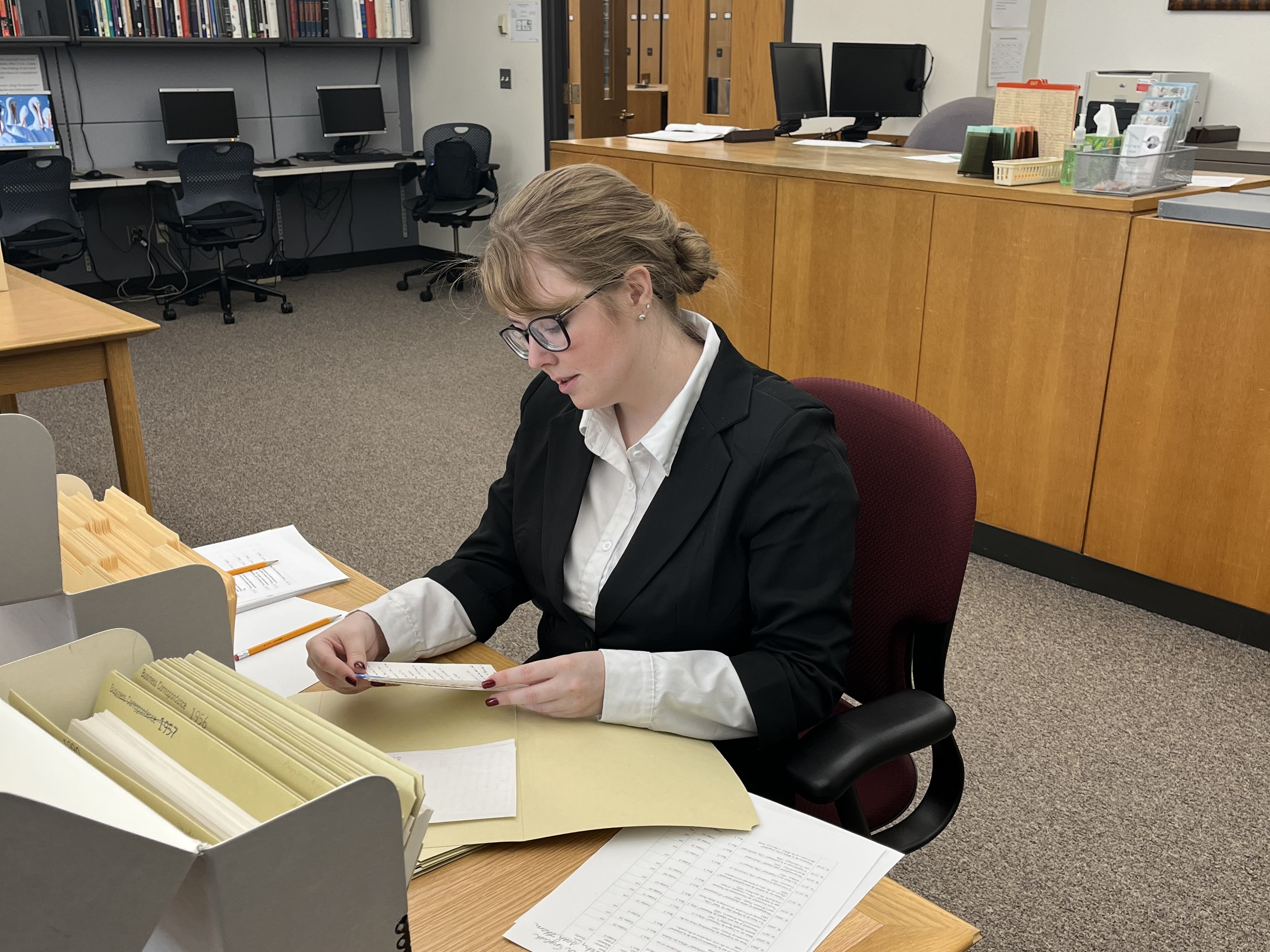Moriah Pitts reading untranslated sermon notes by Jacques Ellul in the archive at Wheaton College.