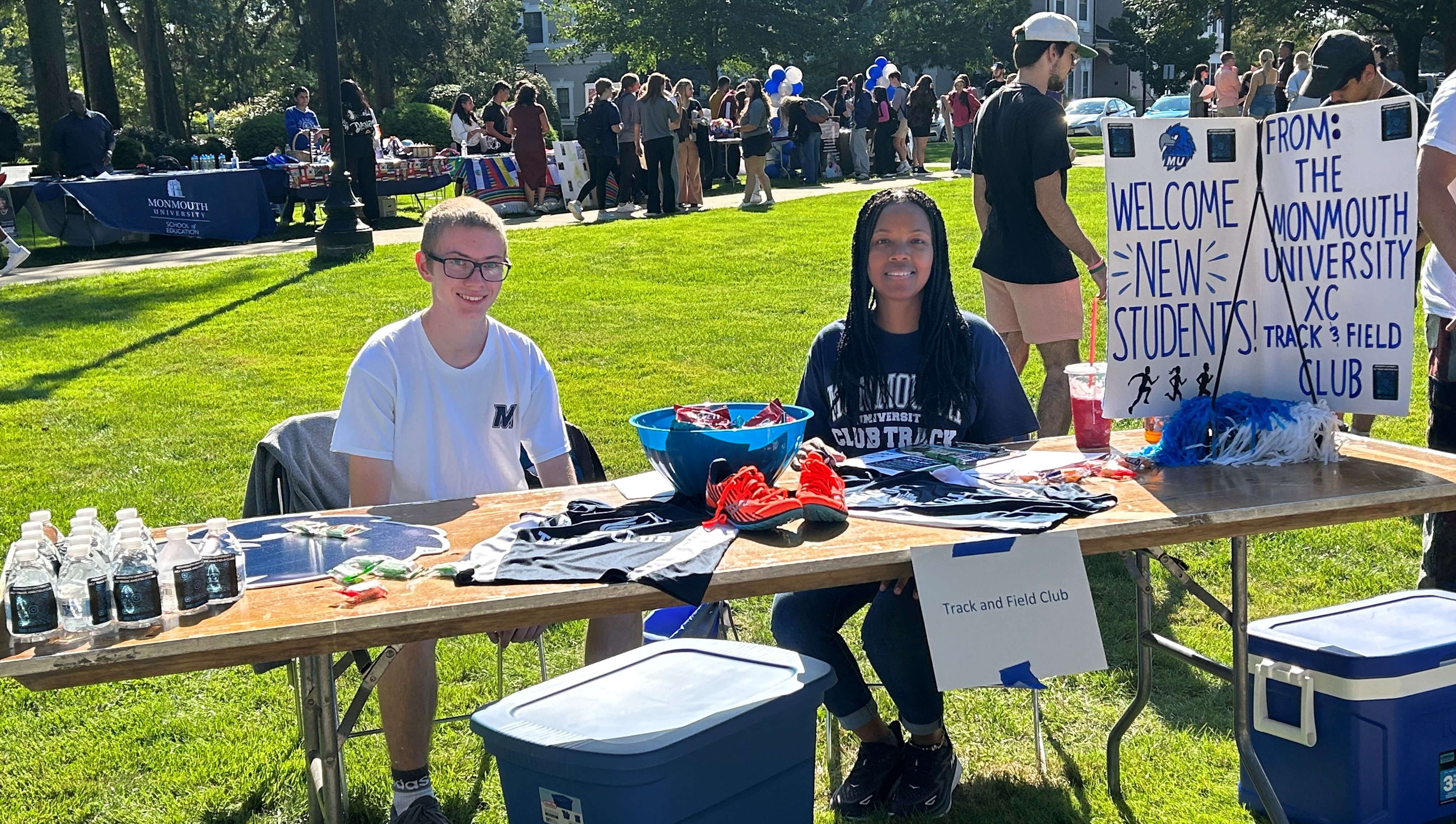 Student and co-advisor representing the club at the involvement fair on campus