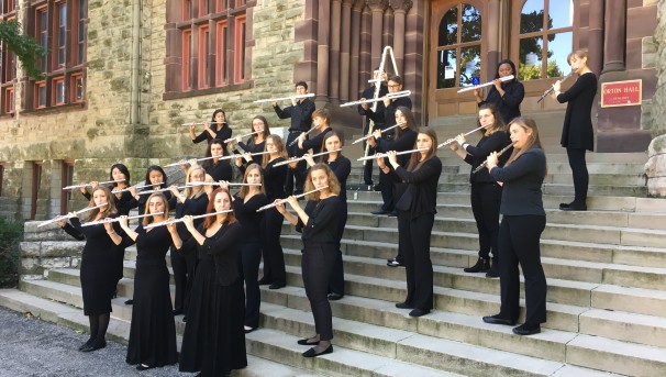 Flute Troupe playing their instruments on the steps to Orton Hall