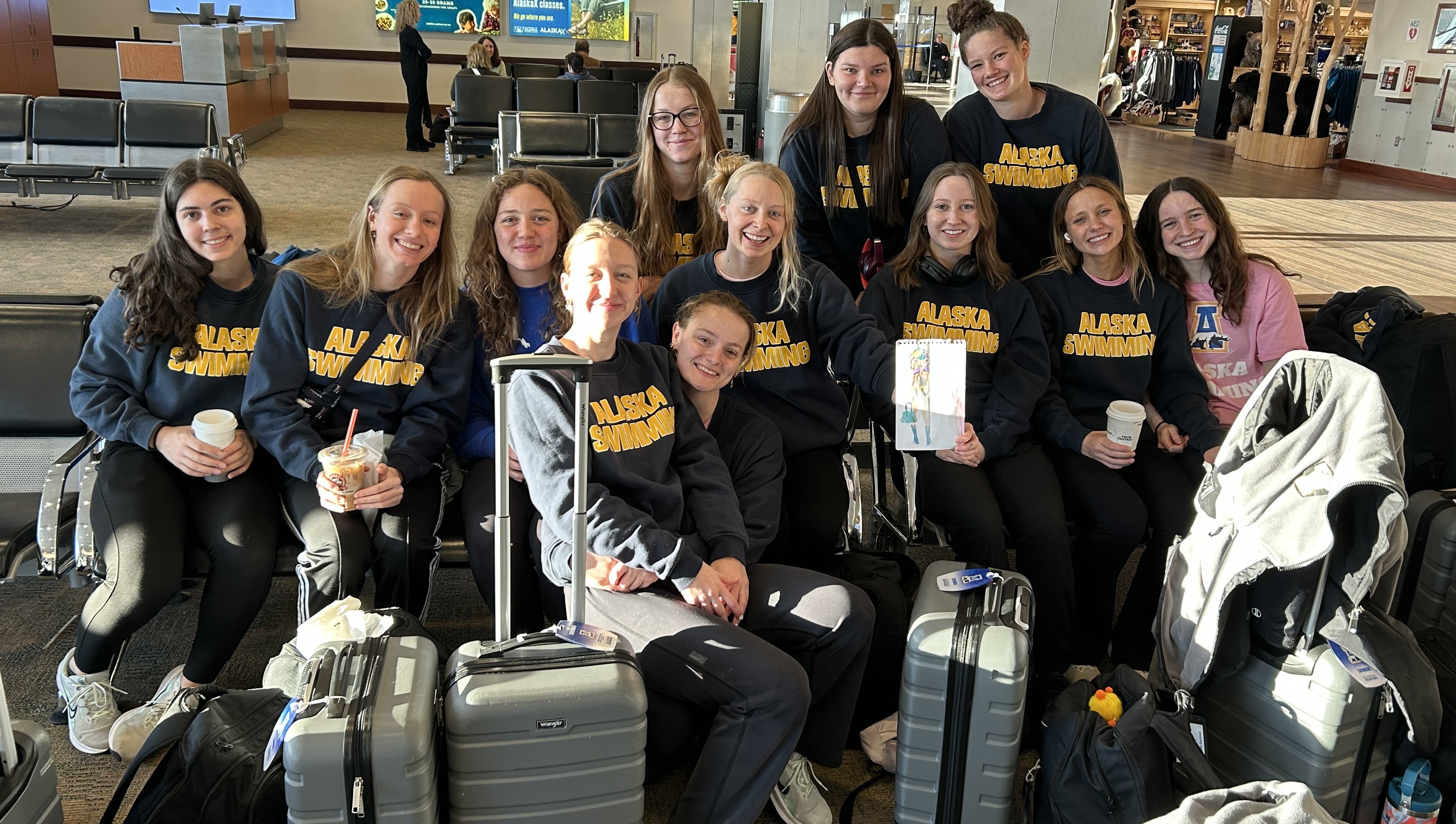 Swim team photo while waiting in the airport in the 2024-25 season.