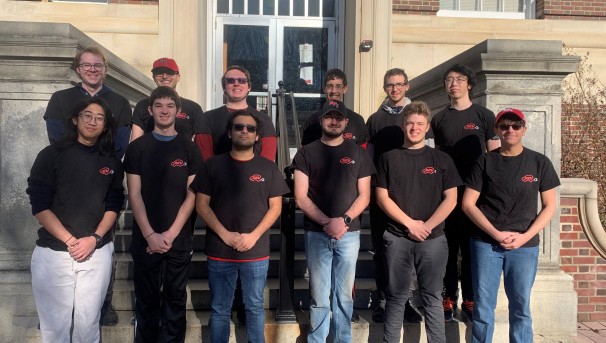 Members of REV standing outside a building on campus