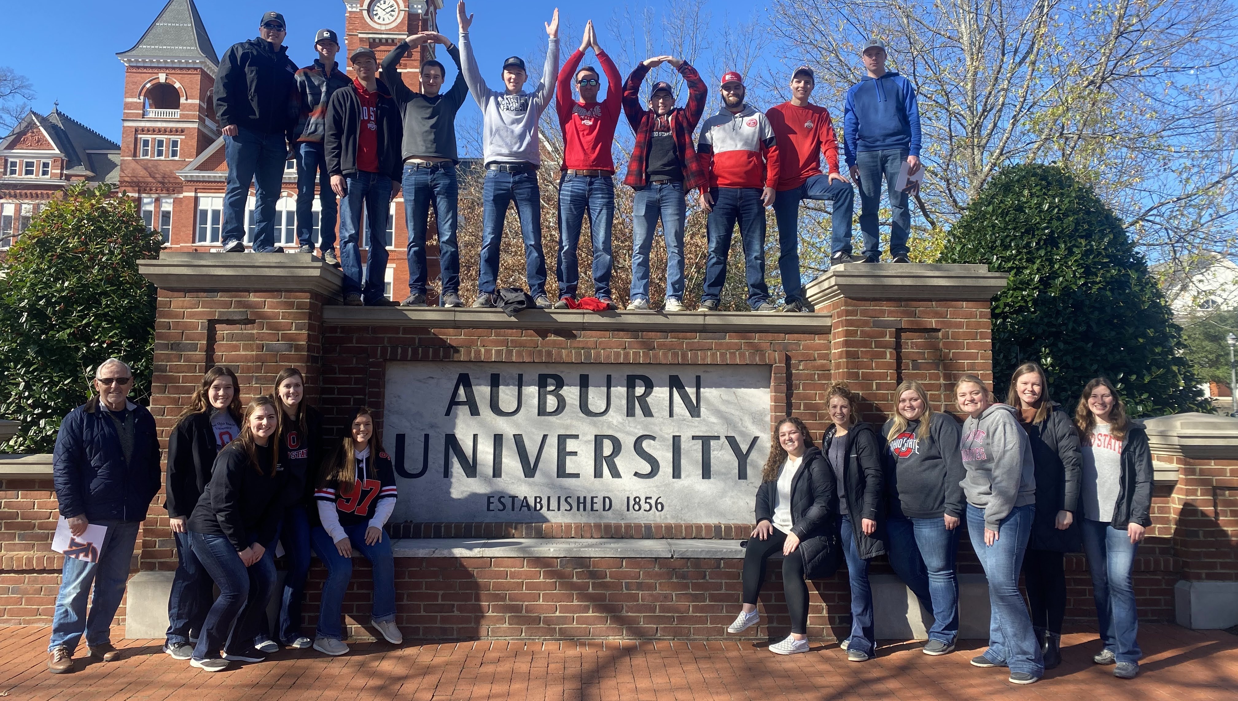 Club members stopped at Auburn University sign during the 2022 club trip