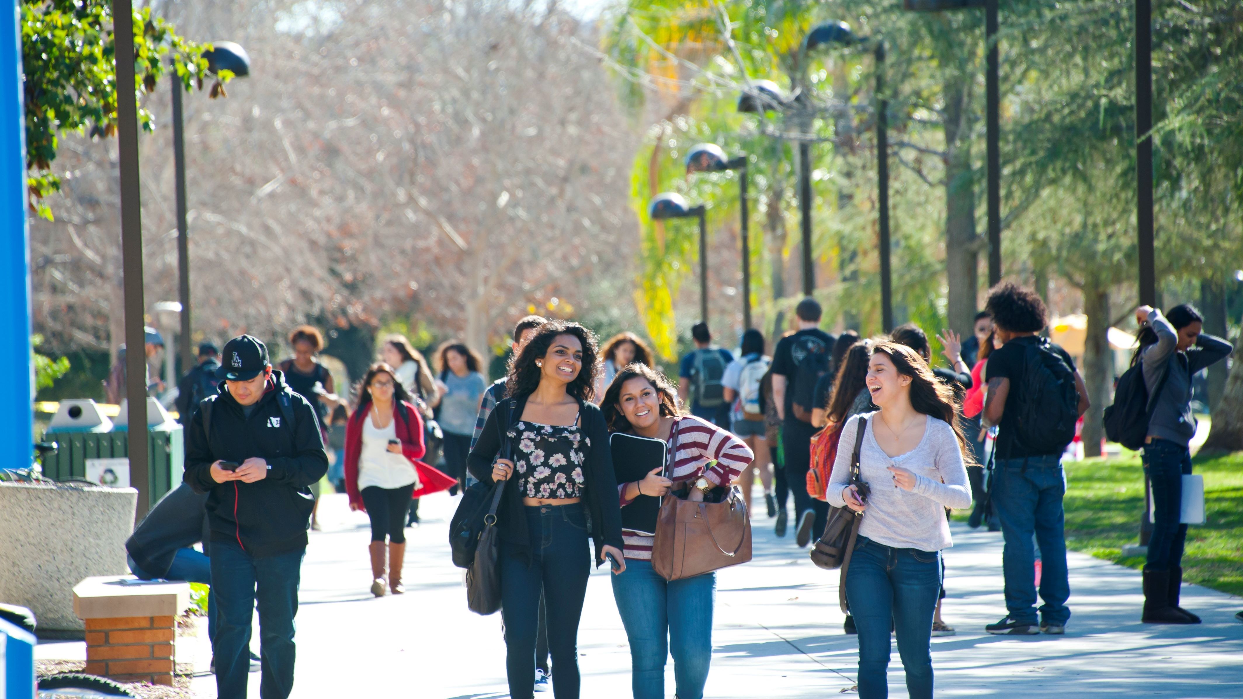 Students walking and smiling on campus