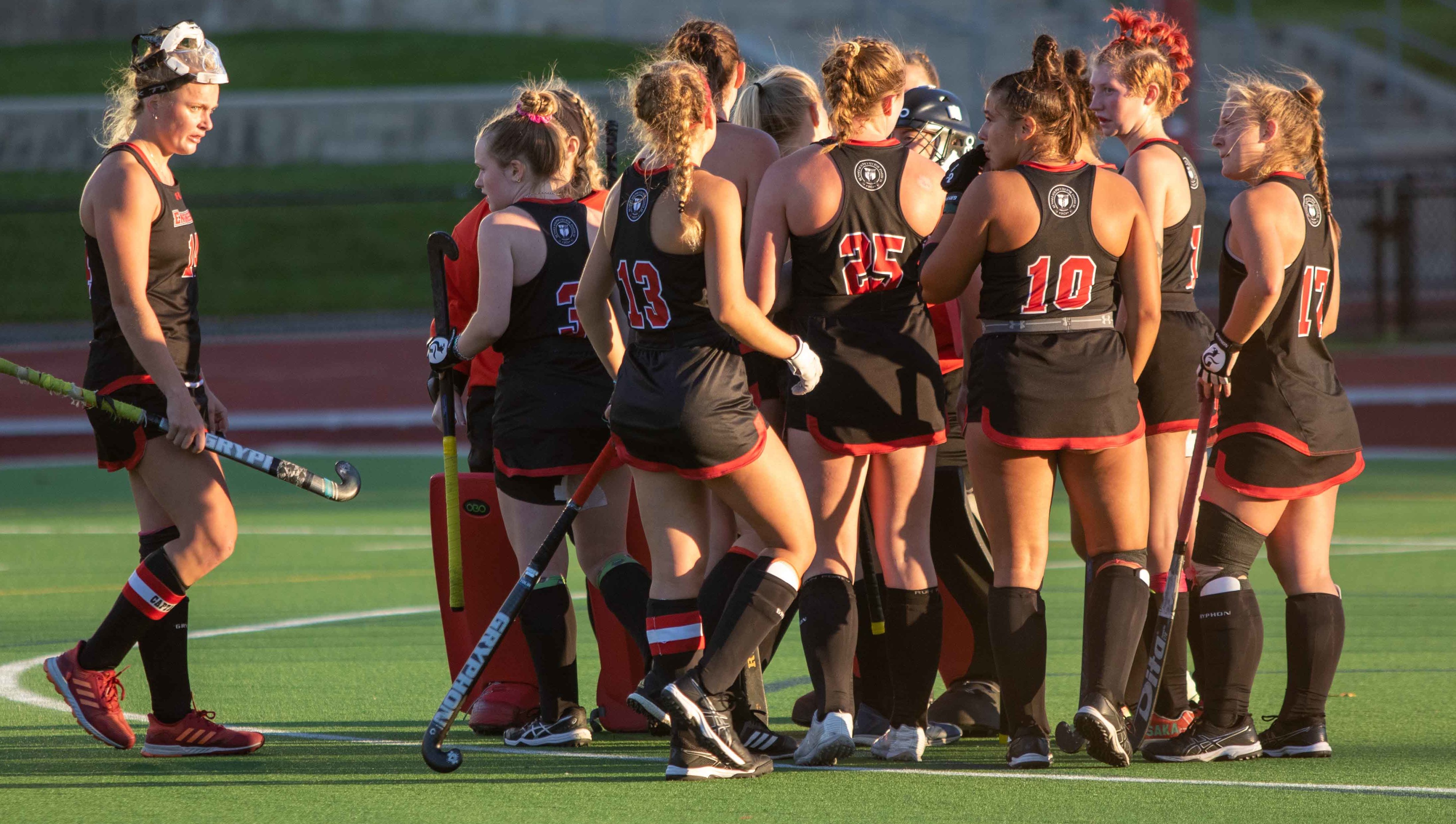 RPI Field Hockey players huddled during a game.