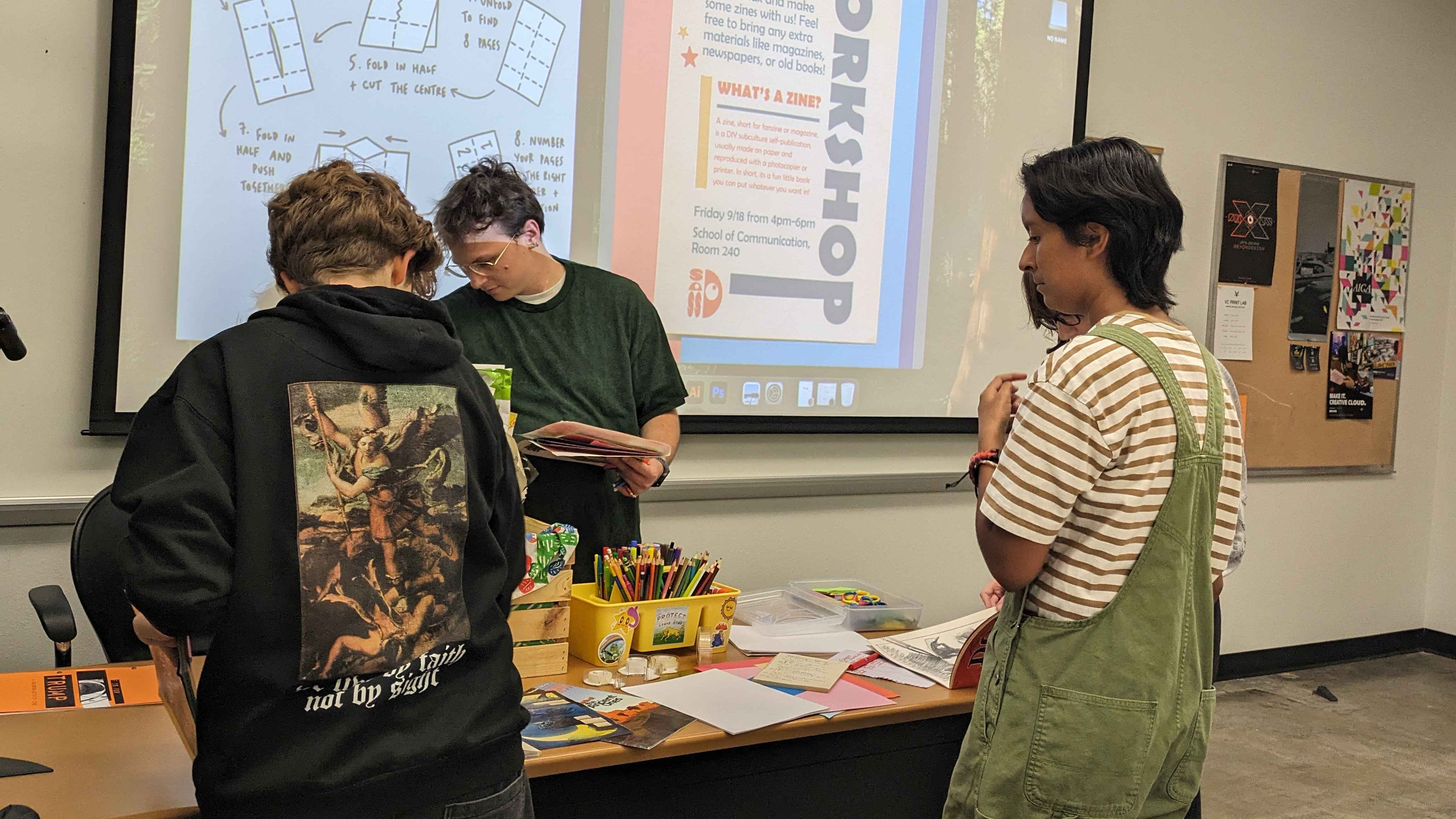 Students getting paper, markers and craft supplies to make Zines.