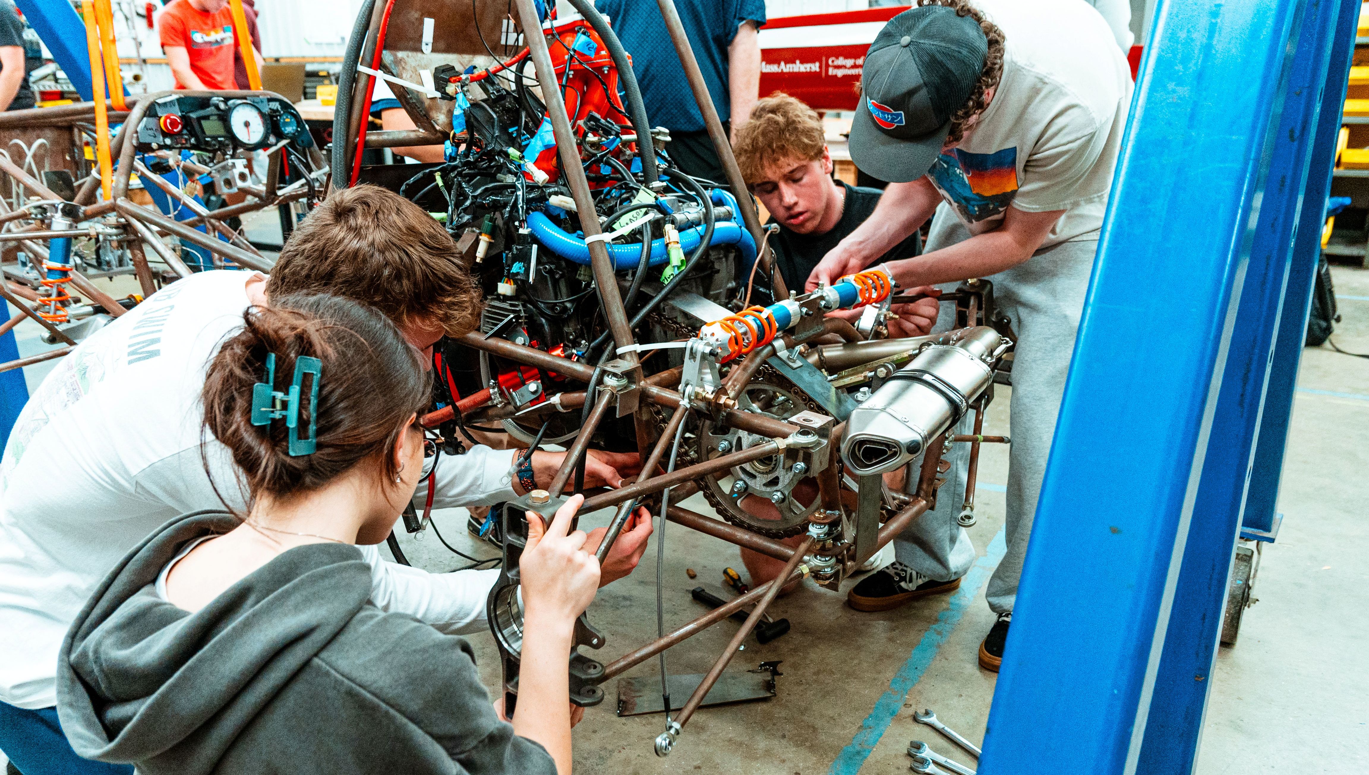 Minutemen racing students working on their car.