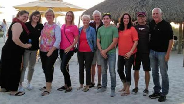 Tampa Bay Hokies gather on the beach.