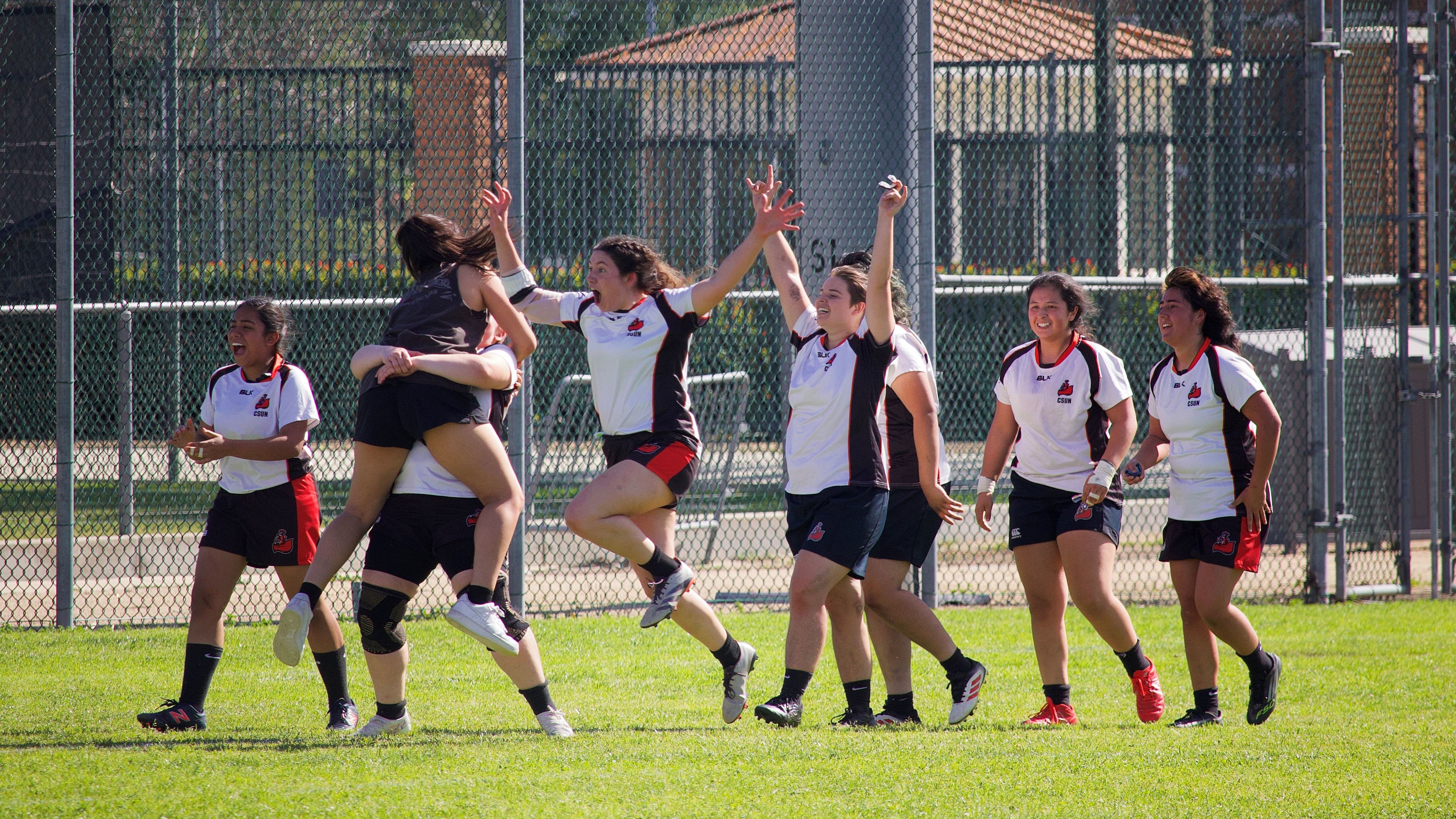 People celebrating a win in soccer