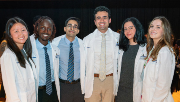 Sponsor School of Medicine Student Stethoscopes and White Coats Image