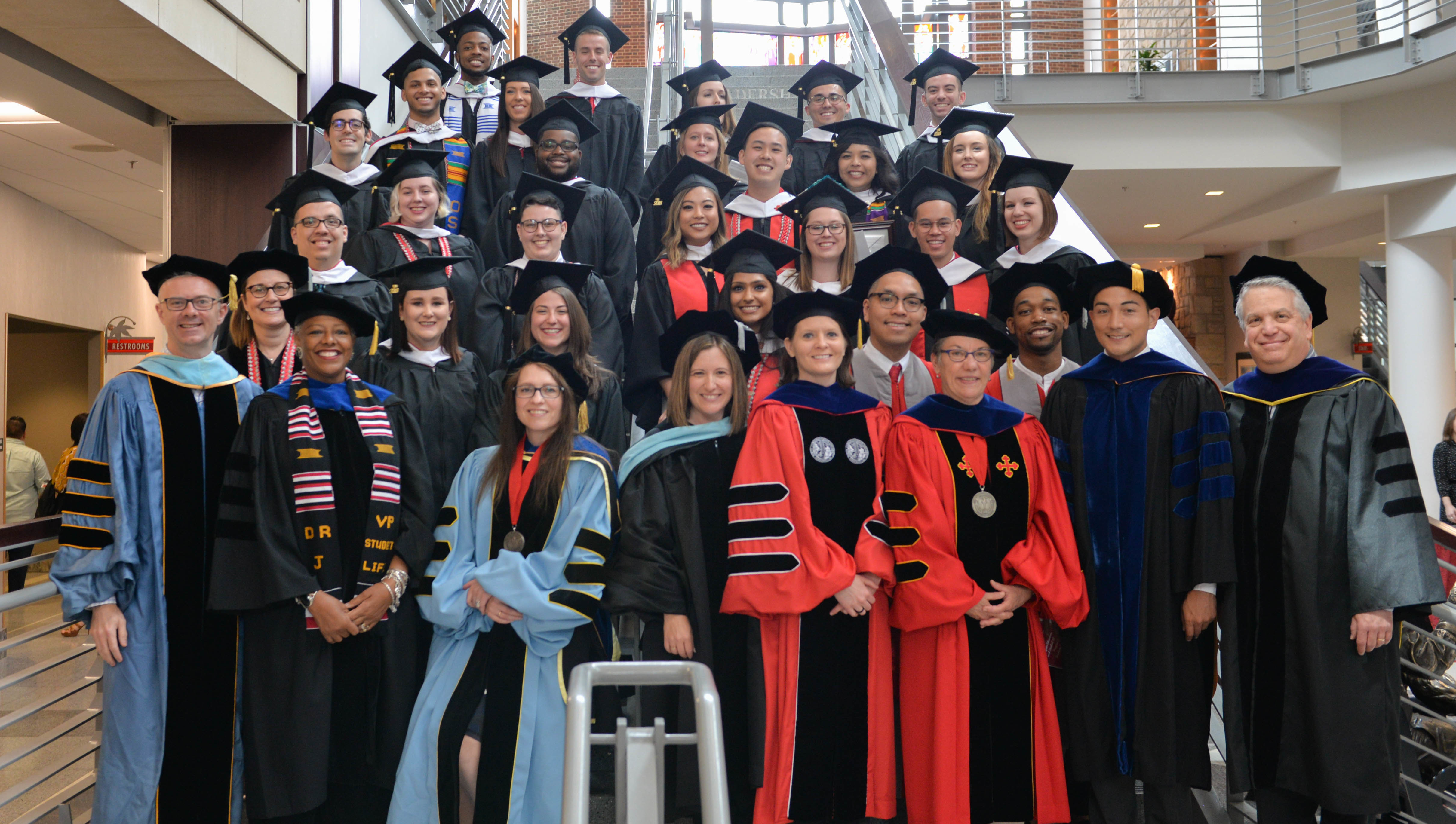 Group of graduates from the 2018 hooding ceremony standing on the Union's steps