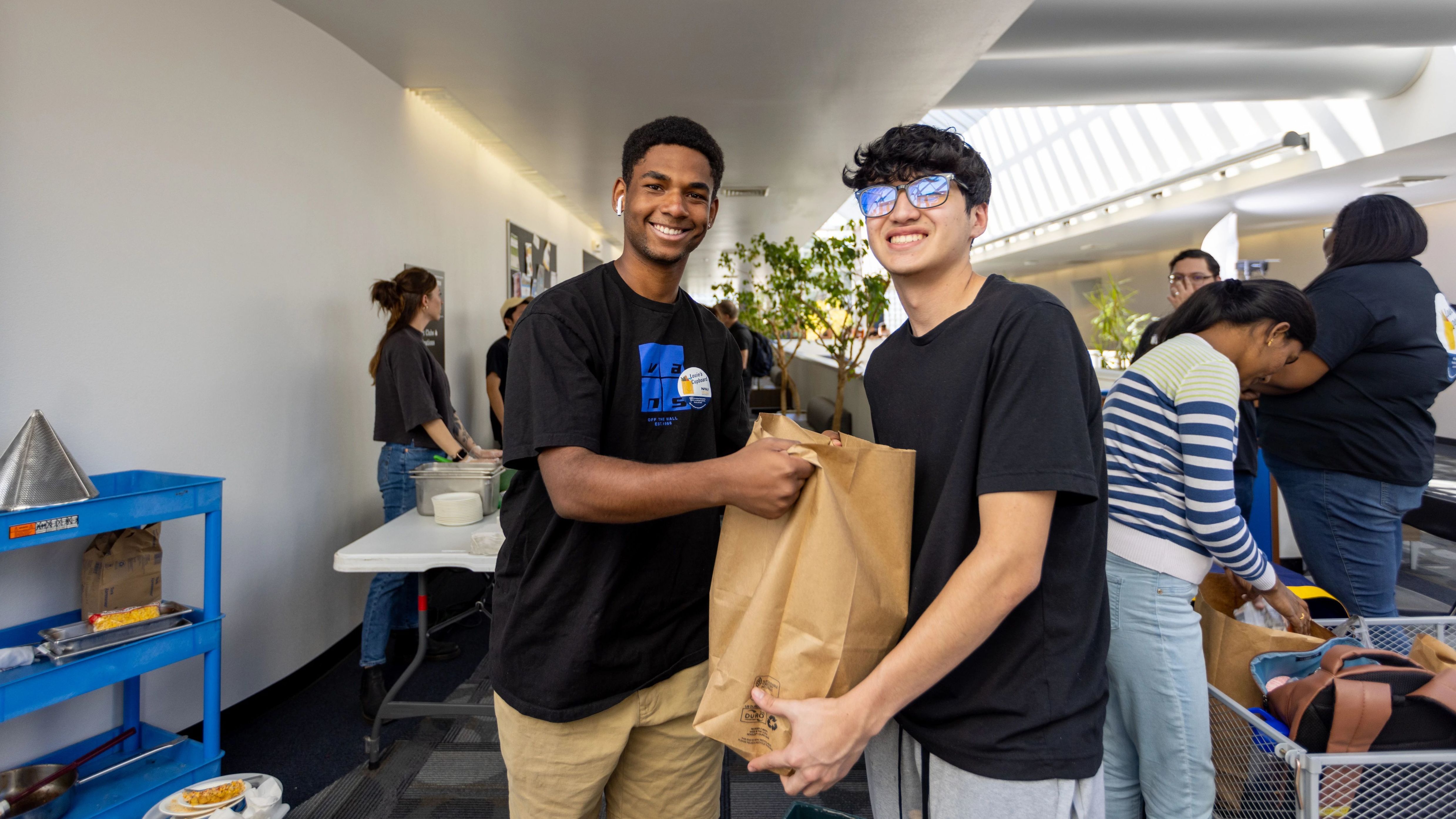 Students collecting food on distribution day at Louie's Cupboard