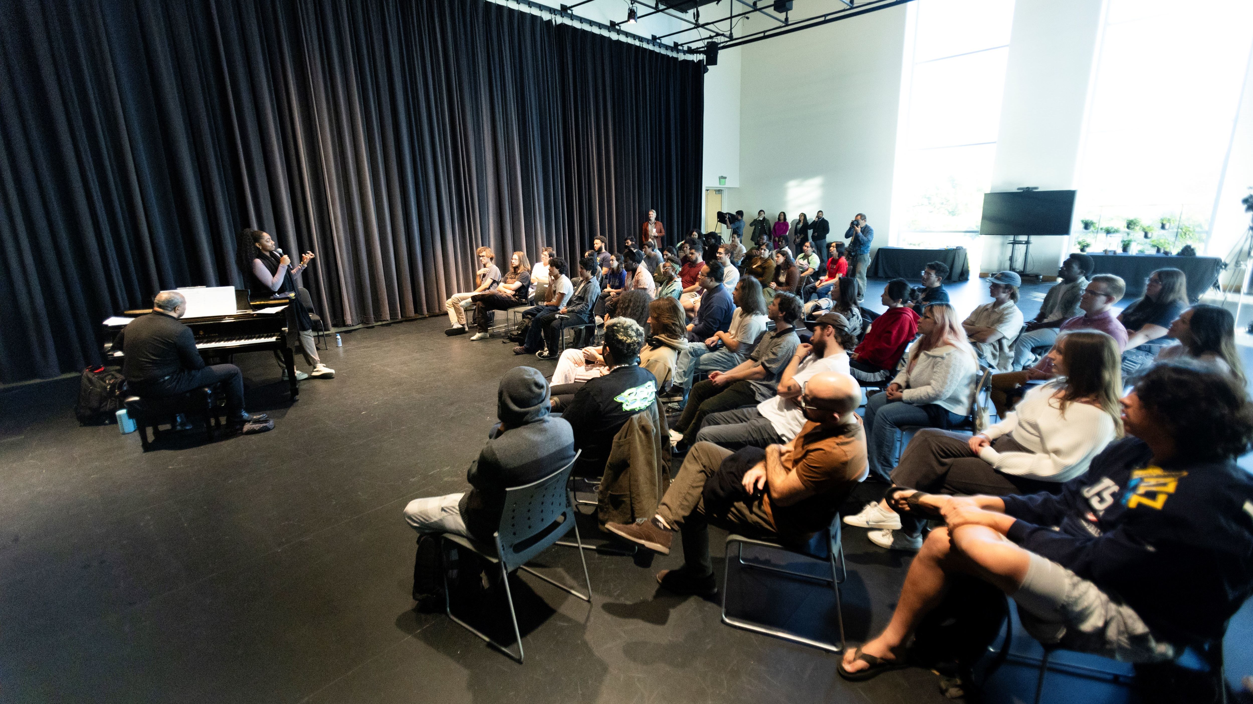 Students watching an artist give a lecture