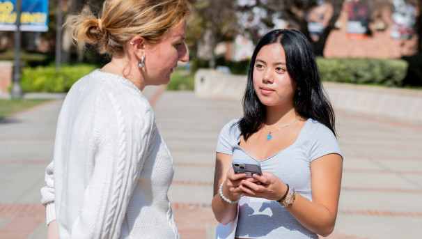 Daily Bruin reporter in action; smart phones have replaced reporters' notebooks