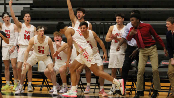 Members of the men's basketball team on the court during a game.