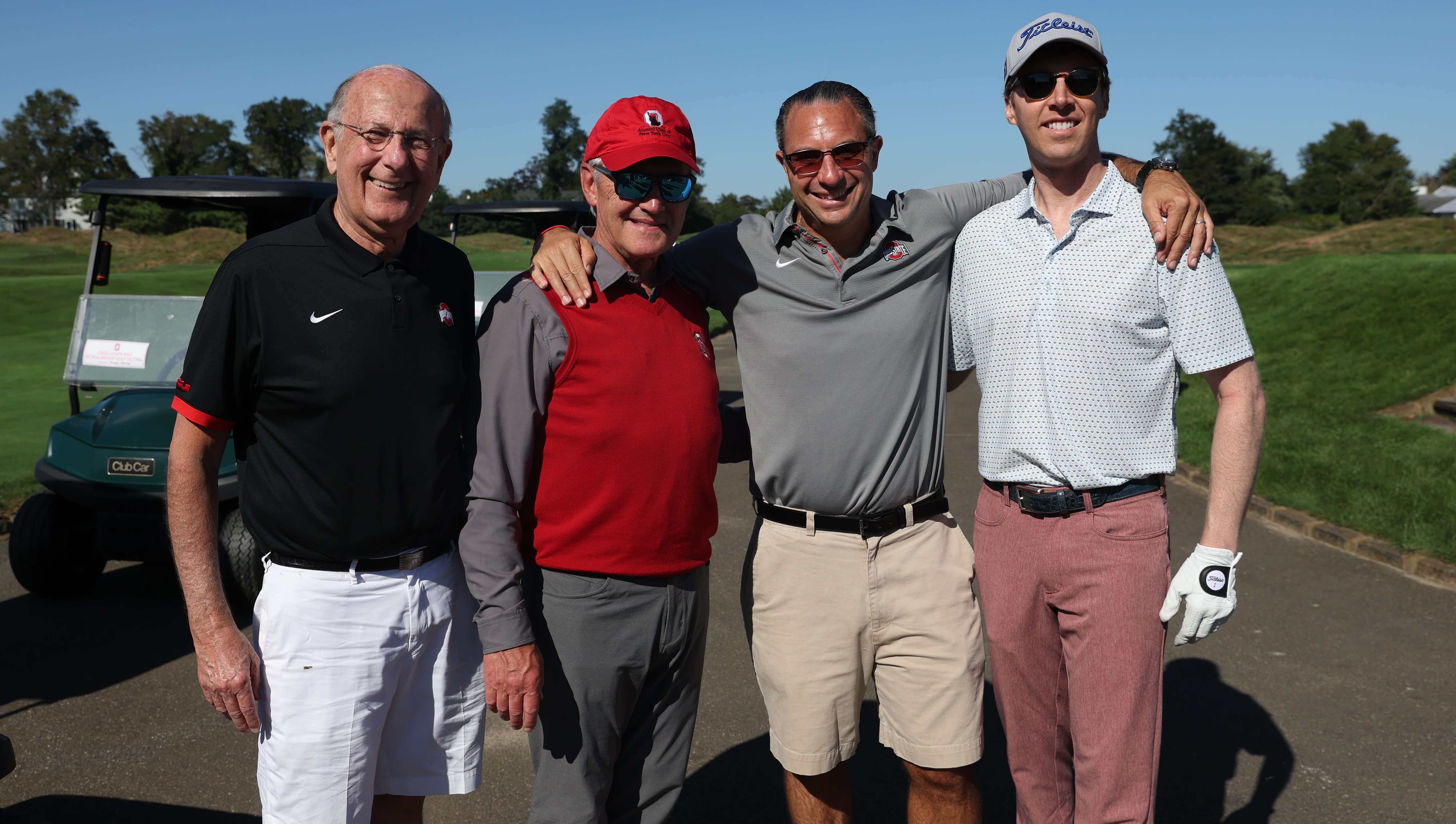 Group of alumni with Coach Jim Tressel at scholarship golf outing