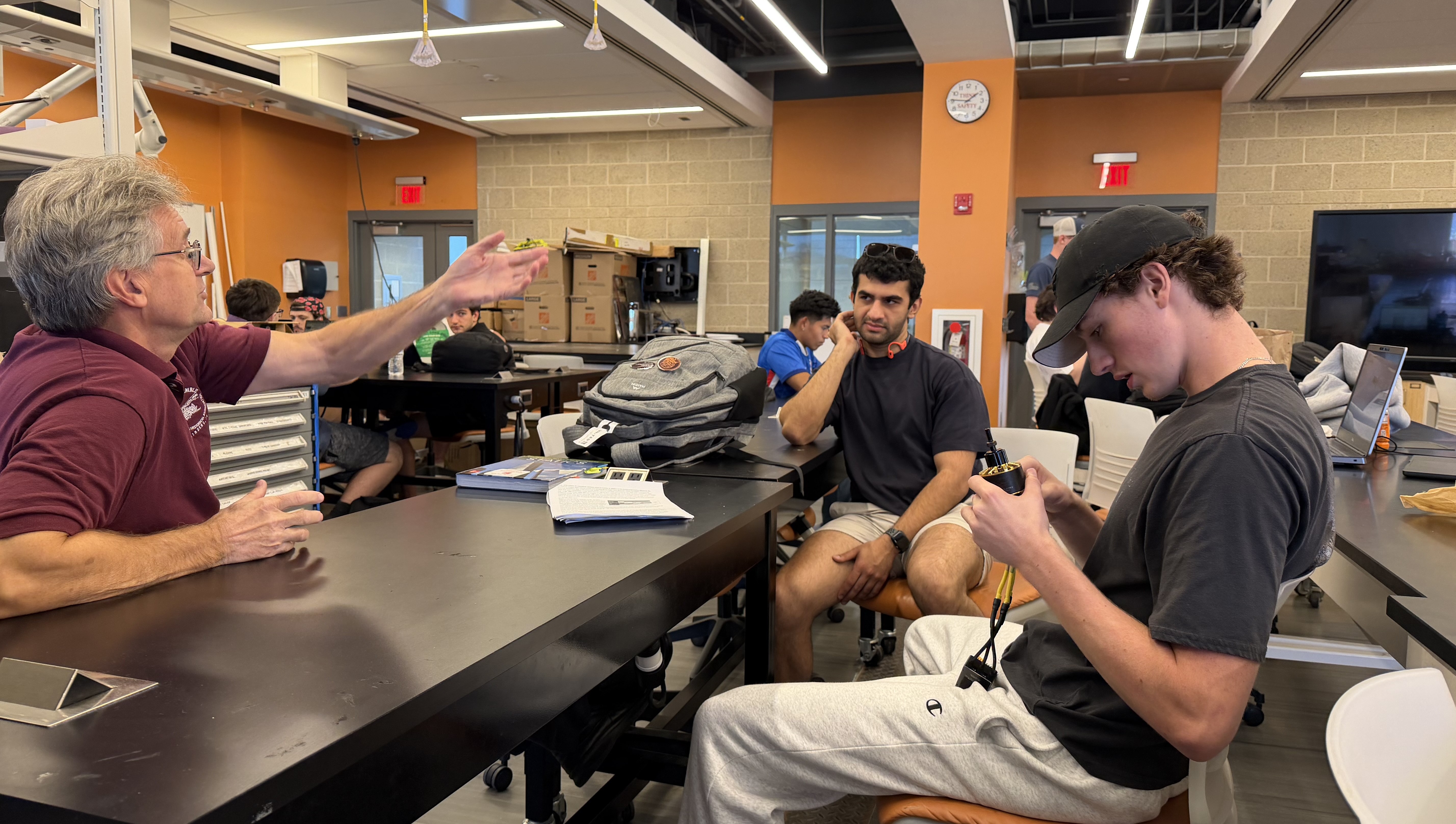 Students working with professor on parts of the plane.