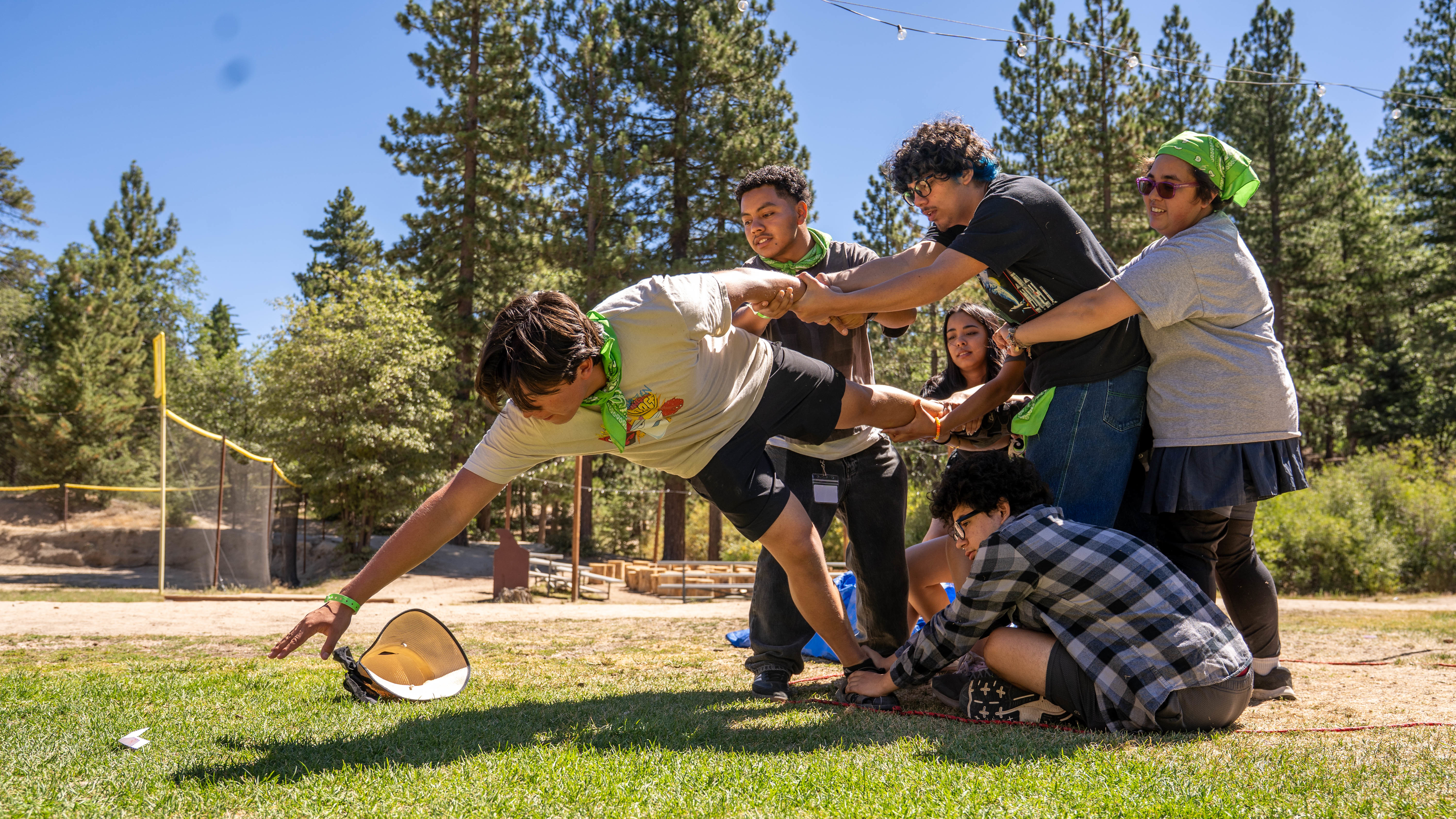 A group of CSUN Students at Camp Matador holding another student during a game of Capture the Flag