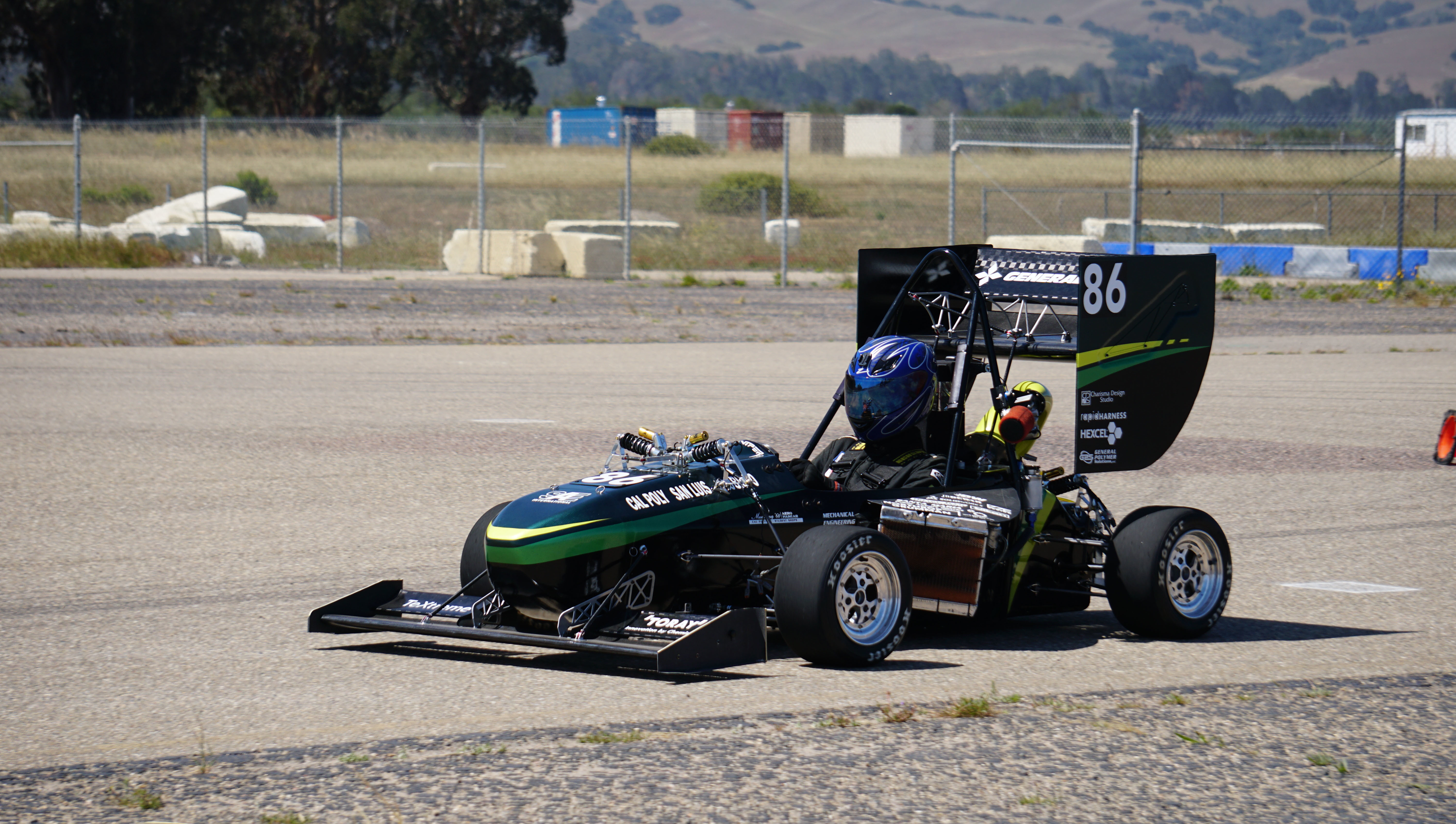 A Cal Poly Racing team member at a competition.