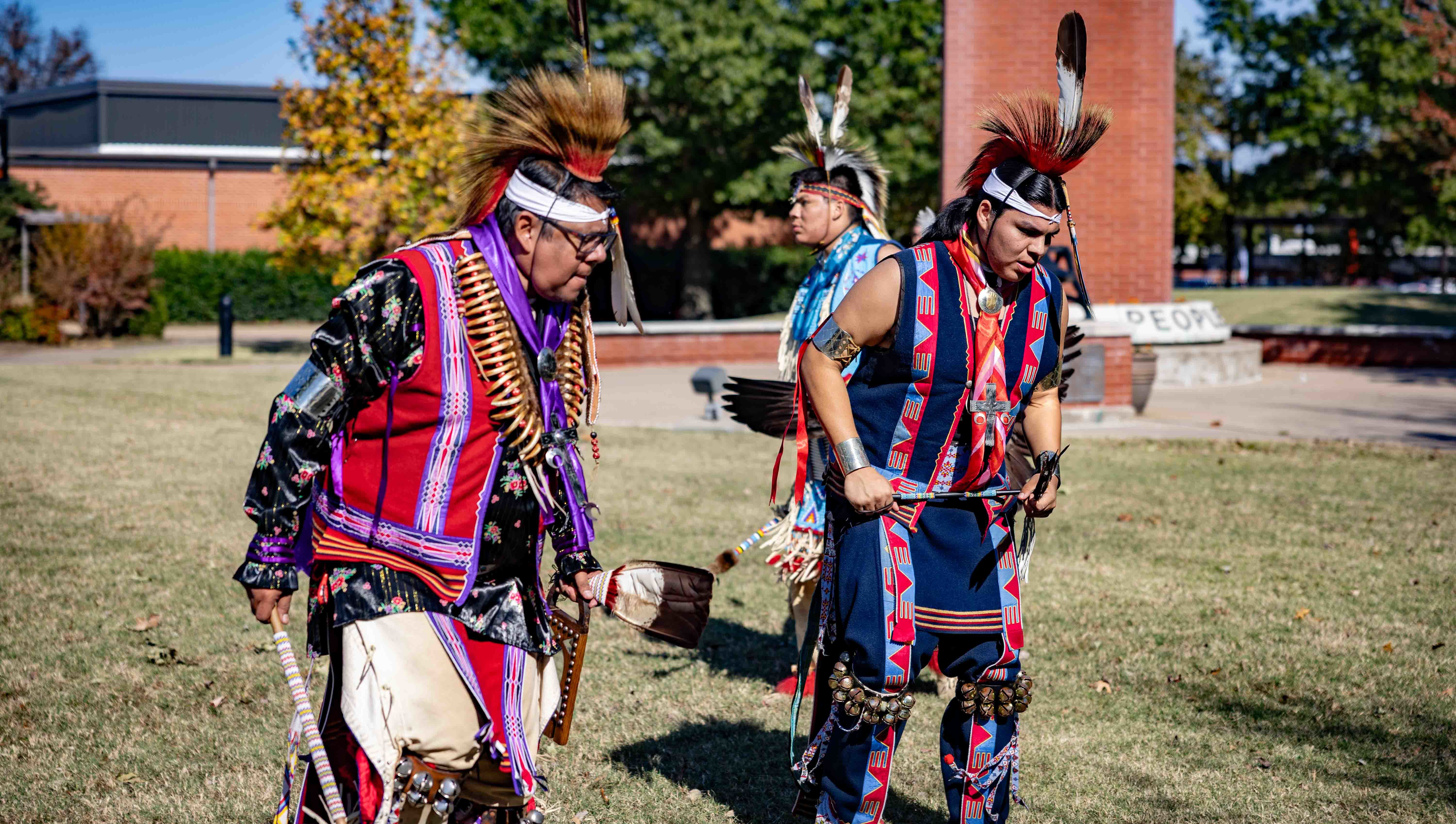 Native American dancers perform for onlookers
