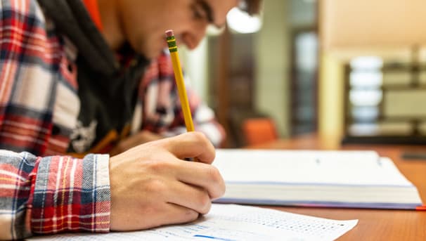 Student with pencil filling in bubble sheet