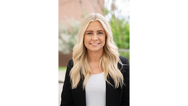 Oliva Corder's professional headshot. She wears a black blazer and a white undershirt