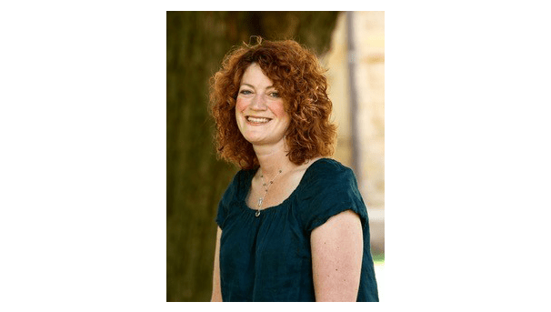 Sonya Dudgeon's professional photo. She is posed before a large tree