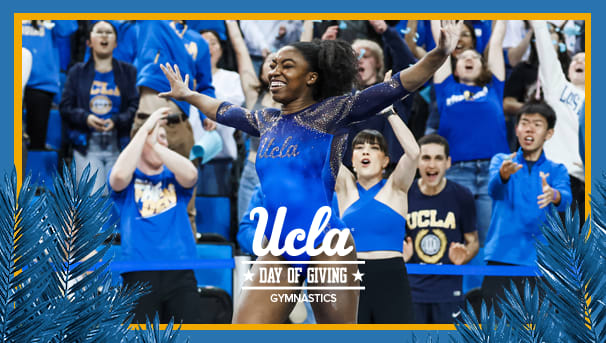 UCLA gymnast smiling in front of a cheering crowd.