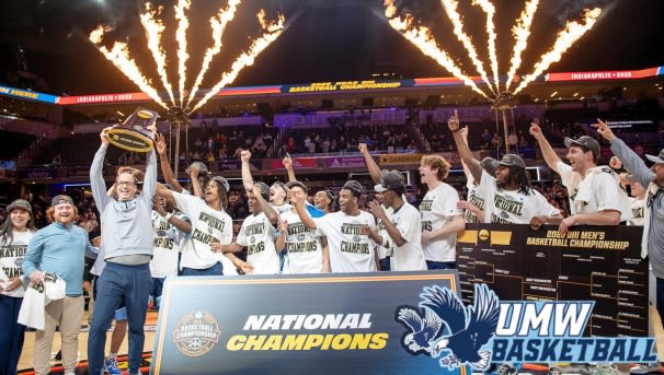 UMW men's basketball team at the NCAA Championship celebrating their win.