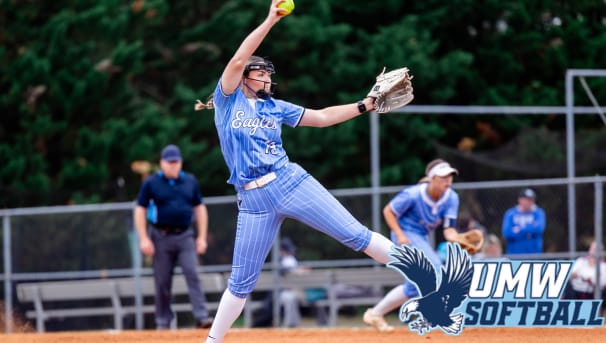 A softball player stares straight ahead at an incoming softball