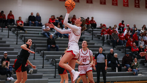 Central College basketball athlete shooting a layup.