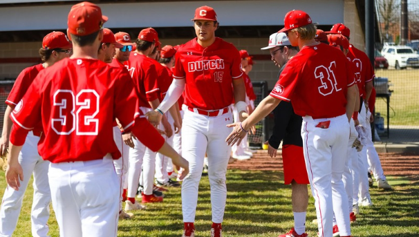 Central Baseball team celebrating in the dugout.
