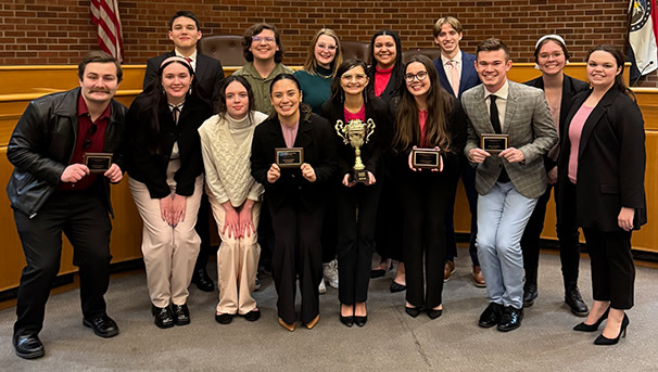 The Mock Trial team standing with their season awards.