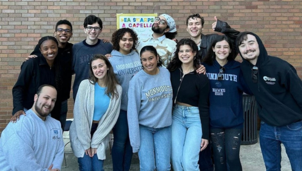 Group of Sea Sharps members smiling for a group photo outside of the Student Center