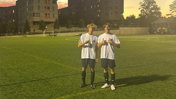 two players in monmouth shirts giving thumbs up on the field