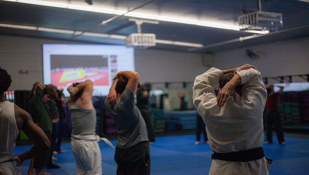 Judo club warming up before instruction