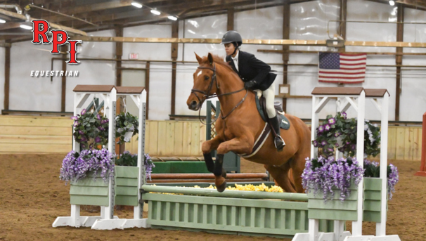Equestrian athlete doing a jump with her horse