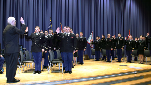 Ohio State Army ROTC officers raising their hands while standing and taking their oath