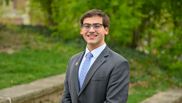 Individual standing outside smiling