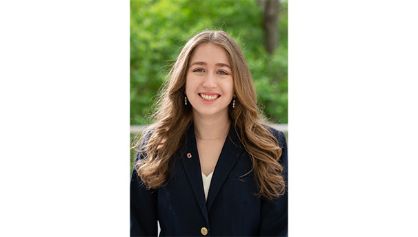 Morgan Gibbs's professional headshot. She wears a closed, black button up