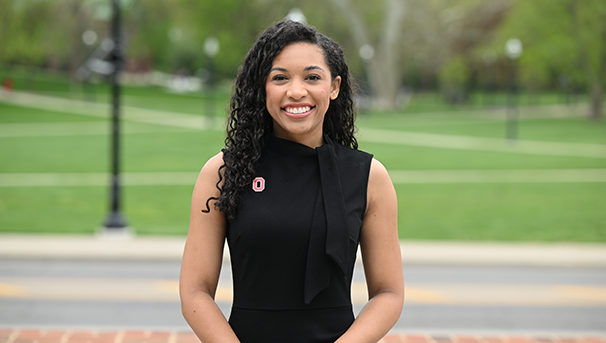 Individual standing outside smiling