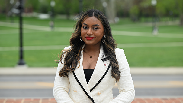 Individual standing outside smiling